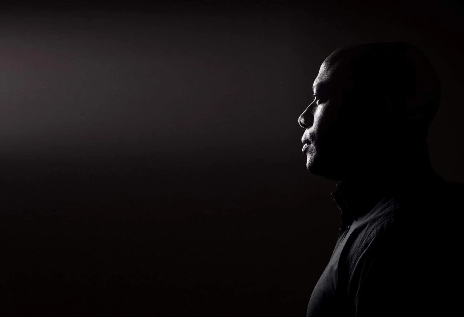 Scott Evans in a low-lit profile portrait