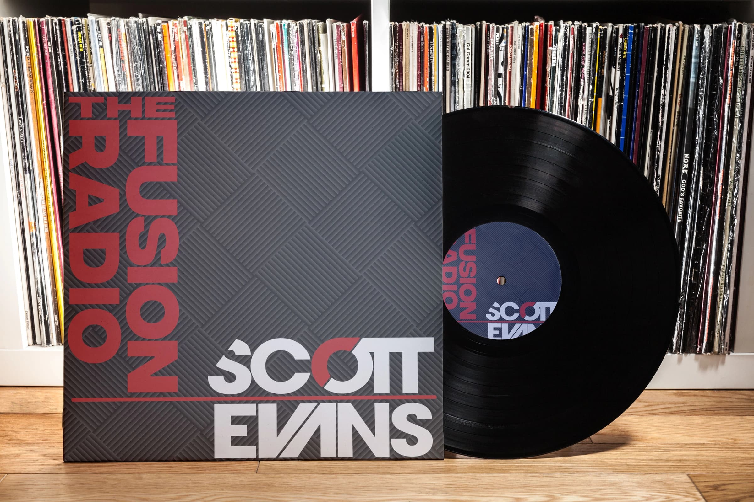 The Fusion Radio sleeve and vinyl artwork in front of a music collection