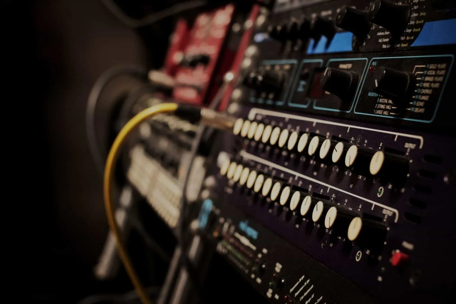 Close-up of studio equipment controls and patch cables